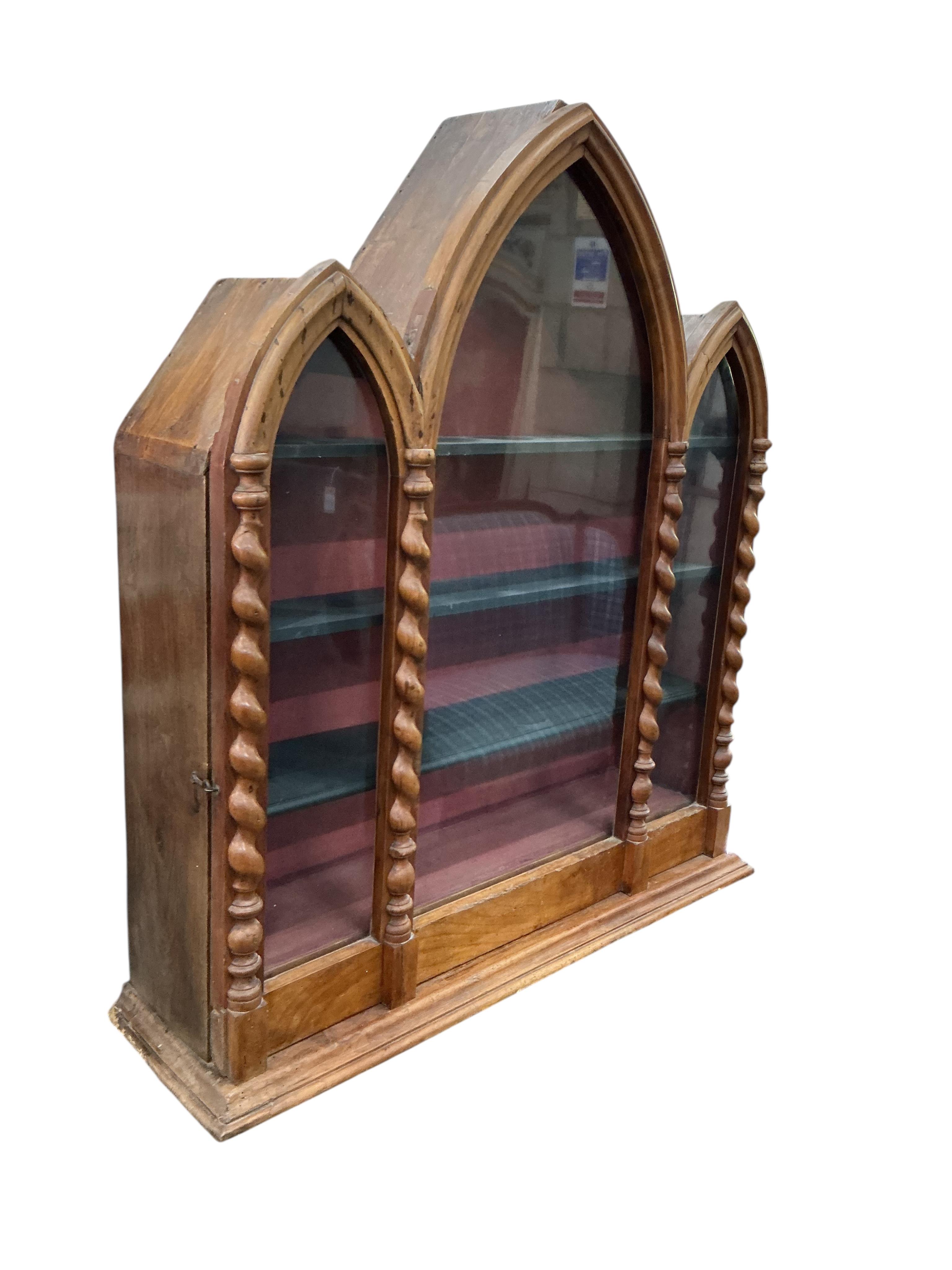 A 19th century French Gothic style walnut and pine triple arched wall display cabinet, width 82cm, depth 32cm, height 97cm